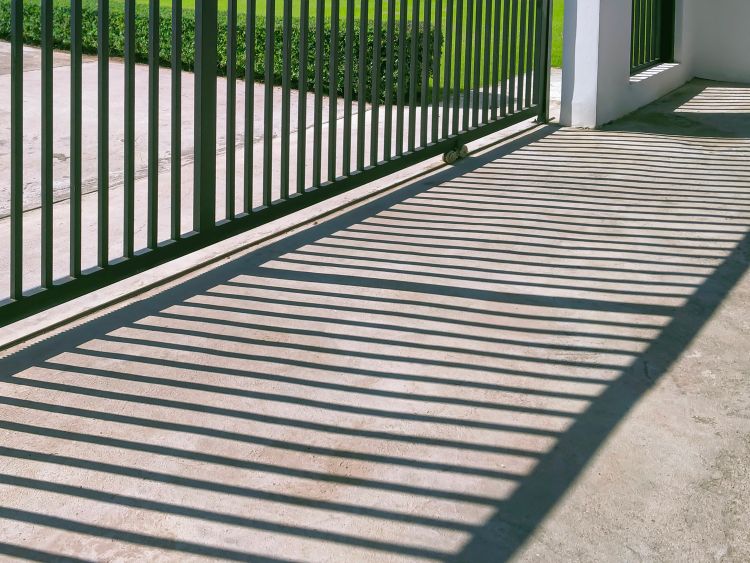Black, metal automatic gate installation by All About Garage Doors in Hillsboro OR