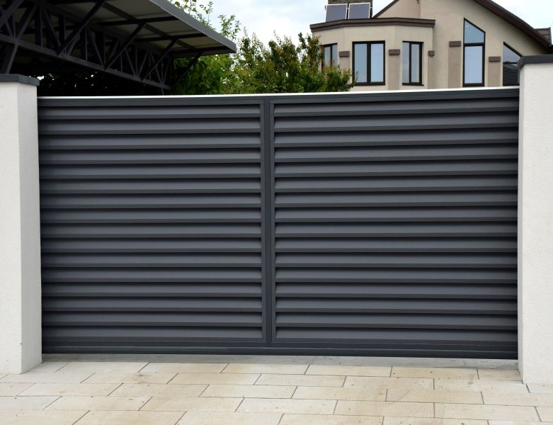 Sleek black automatic gate installed on Tigard OR property by All About Garage Doors