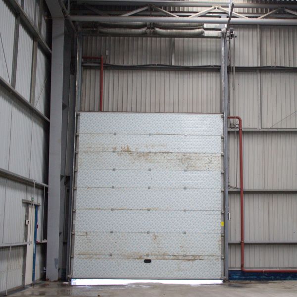 Commercial garage door stuck open before getting repair by All About Garage Doors in Lake Oswego, OR before an emergency garage door service