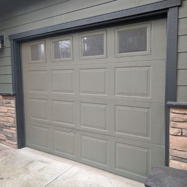 Green/grey garage door after a completed emergency garage door service by All About Garage Doors in Tigard OR