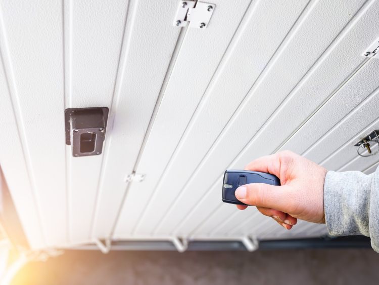 Testing a garage remote opener after an emergency garage door service from All About Garage Doors in Newberg OR