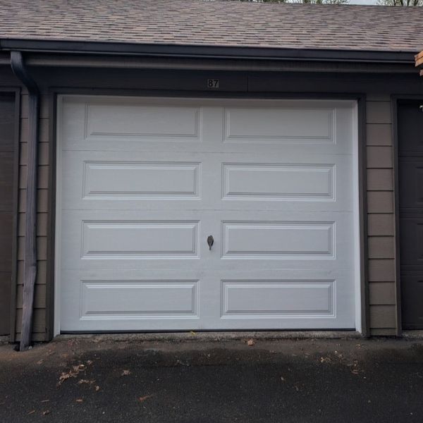 White garage door before All About Garage Doors executes an emergency garage door service in Tigard OR