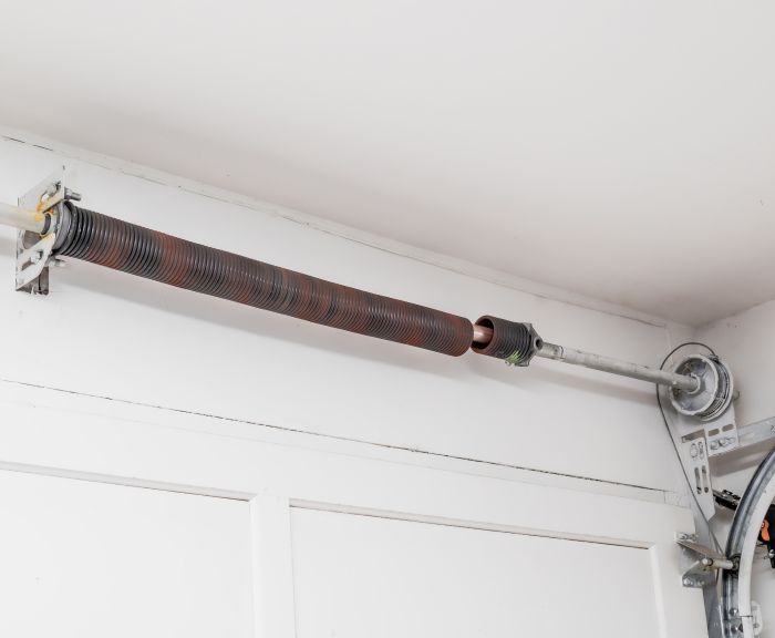 Broken spring before getting replaced during an emergency garage door service by All About Garage Doors in Forest Grove OR