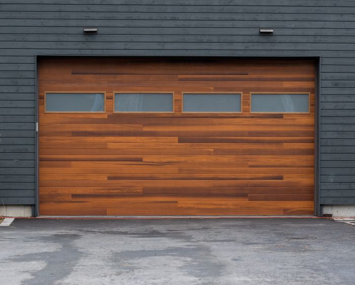 Dark gray home with brand new wood garage door installation completed by All About Garage Doors in Milwaukie OR