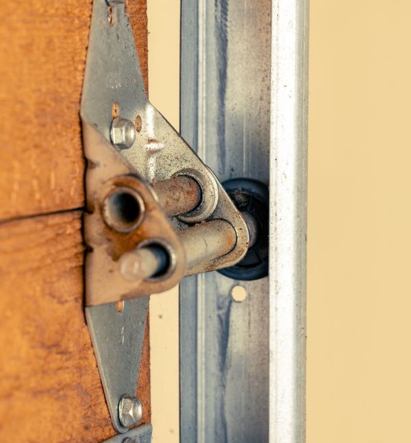 Inspecting the moving parts of a garage door during garage door maintenance by All About Garage Doors in Lake Oswego OR