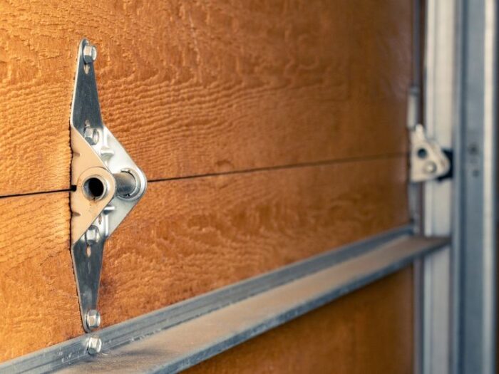 Up close inspection of moving parts during garage door maintenance by All About Garage Doors in Milwaukie OR