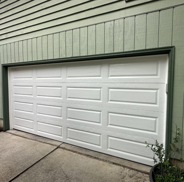 Two-tone green home received garage door maintenance from All About Garage Doors in Tigard OR