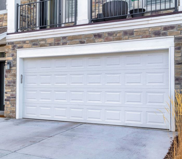 A freshly repaired, white garage door by All About Garage Doors in Lake Oswego OR