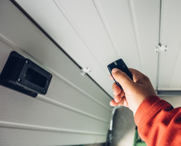 Testing the door remote after a garage door repair in Milwaukie OR by All About Garage Doors