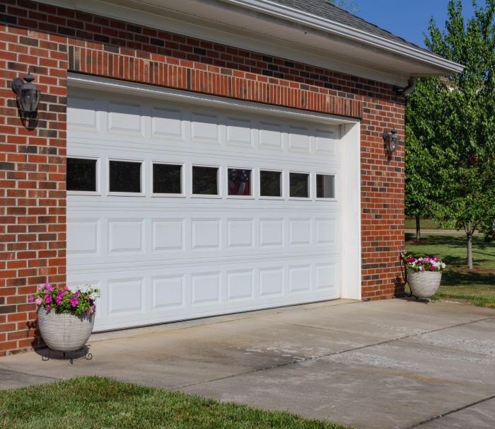 Brick house with a newly replaced garage door completed by All About Garage Doors in Beaverton OR
