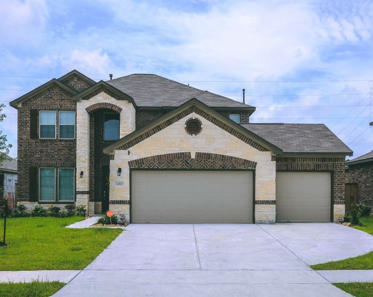 Beautiful stone home after a garage door replacement completed by All About Garage Doors in Hillsboro OR
