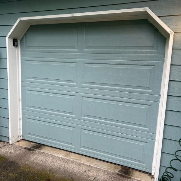 Blue/green home gets a garage door replacement by All About Garage Doors in Tualatin OR