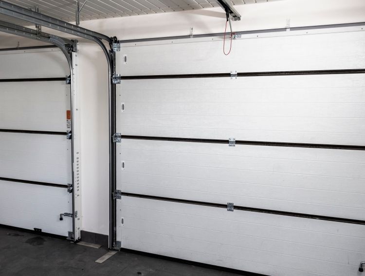 Ensuring all moving parts are functional after a garage door replacement completed by All About Garage Doors in Newberg OR