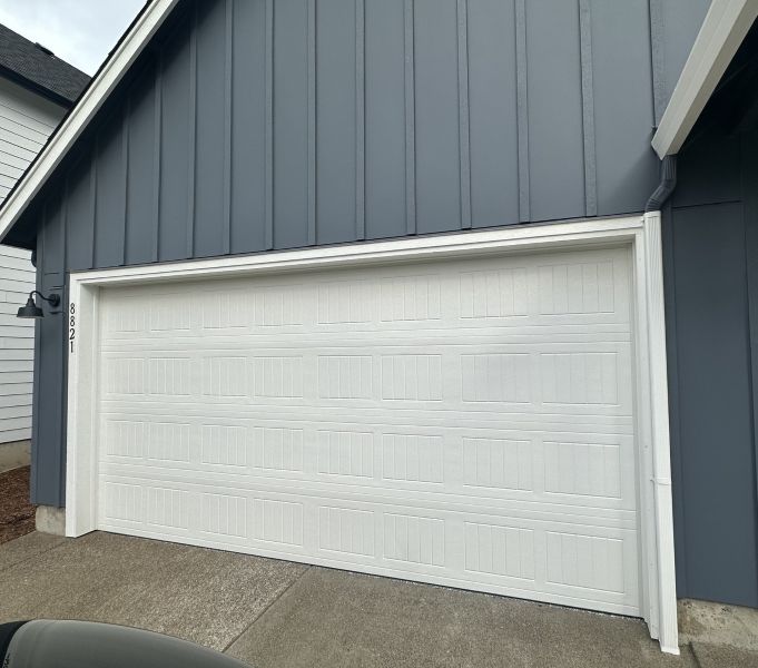 Grey home with a new garage door replacement executed by All About Garage Doors in Tualatin OR