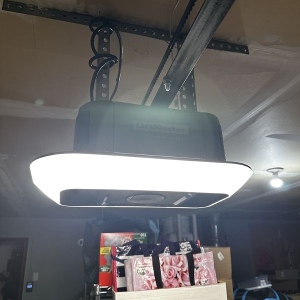 Garage door motor getting fixed during an emergency garage door repair by All About Garage Doors in Raleigh Hills OR