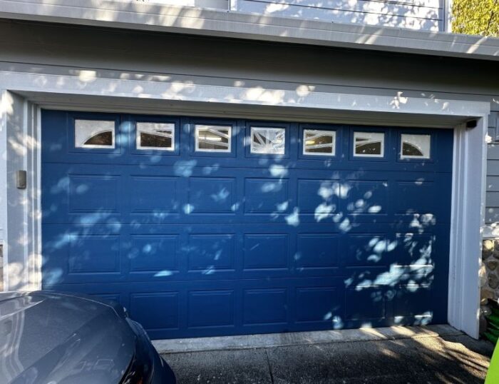 Royal blue garage door received a garage door repair service from All About Garage Doors in Bridlemile Portland OR