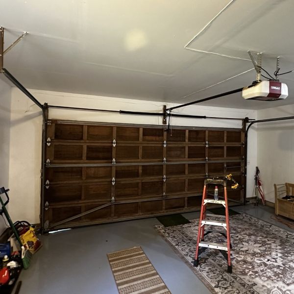 Wooden garage door receives a garage spring replacement completed by All About Garage Doors