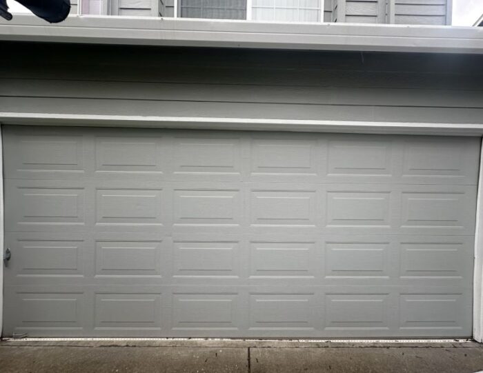 Grey home and garage door gets an emergency garage door service completed by All About Garage Doors