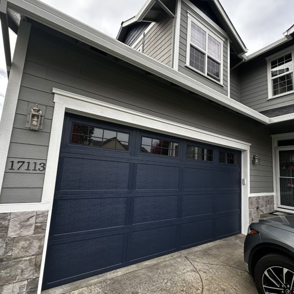 Grey home with dark blue garage door get garage door services from All About Garage Doors in Multnomah Village Portland OR